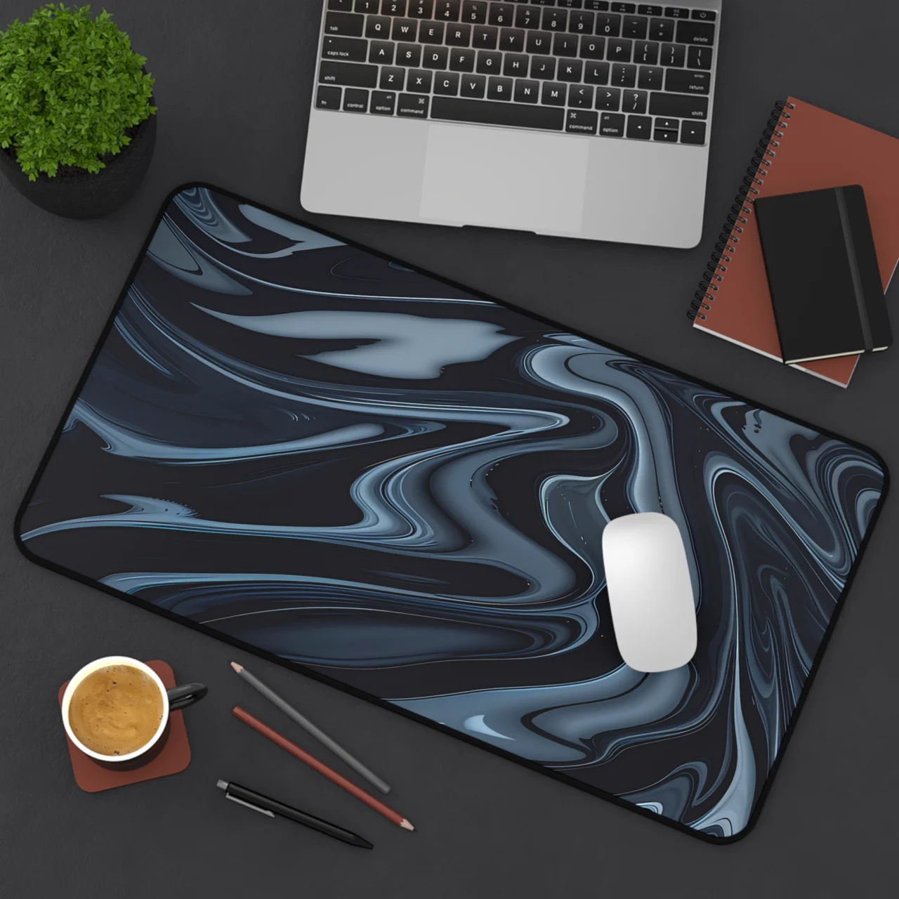 Extended Dark Liquid Marble Desk Mat featuring a dark blue and grey abstract liquid marble swirl pattern, placed on a black desk with a laptop, mouse, and coffee cup.