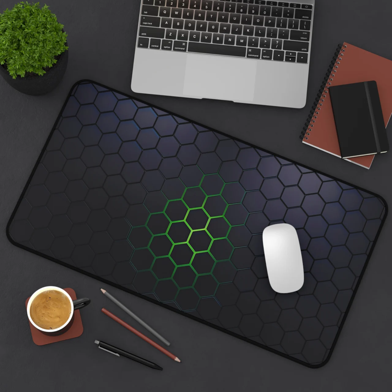 Extended Neon Green Hexagon Gaming Desk Mat featuring a dark gray and black hexagon honeycomb pattern with a glowing neon green center, shown on a dark desk with a laptop and mouse.