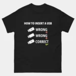 A black Funny USB Superposition Graphic Tee showing a 3-step graphic titled "HOW TO INSERT A USB" where the first two tries are marked WRONG and the third is CORRECT. This is a Funny Relatable Tech Hardware How to Insert a USB T-Shirt