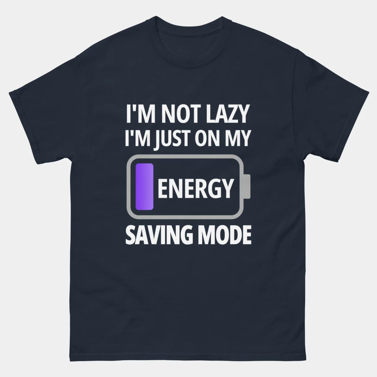 A navy blue Funny Low Battery Tech Graphic Tee with white text and a battery icon stating "I'M NOT LAZY I'M JUST ON MY ENERGY SAVING MODE". This is a Funny Tech Battery I'm Not Lazy Energy Saving Mode T-Shirt
