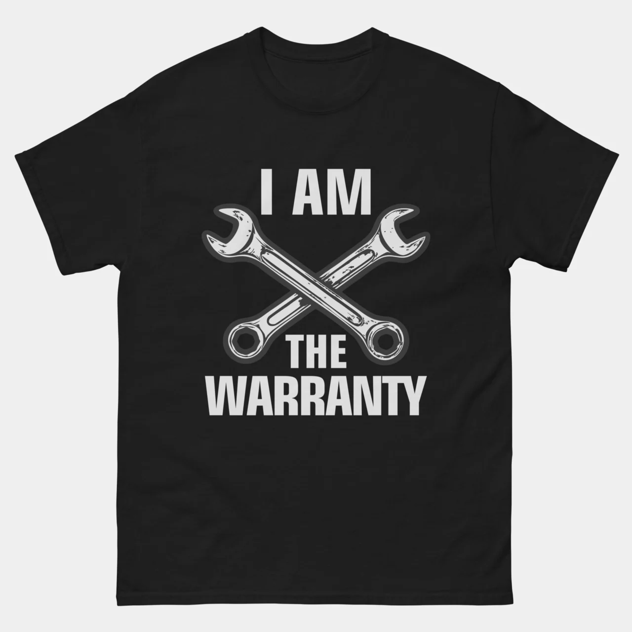 Black I Am The Warranty T-Shirt - Funny Mechanic Engineer Shirt with bold white text reading I Am The Warranty flanked by two crossed wrenches graphic, humorous DIY repair and engineering gift tee for mechanics and technicians