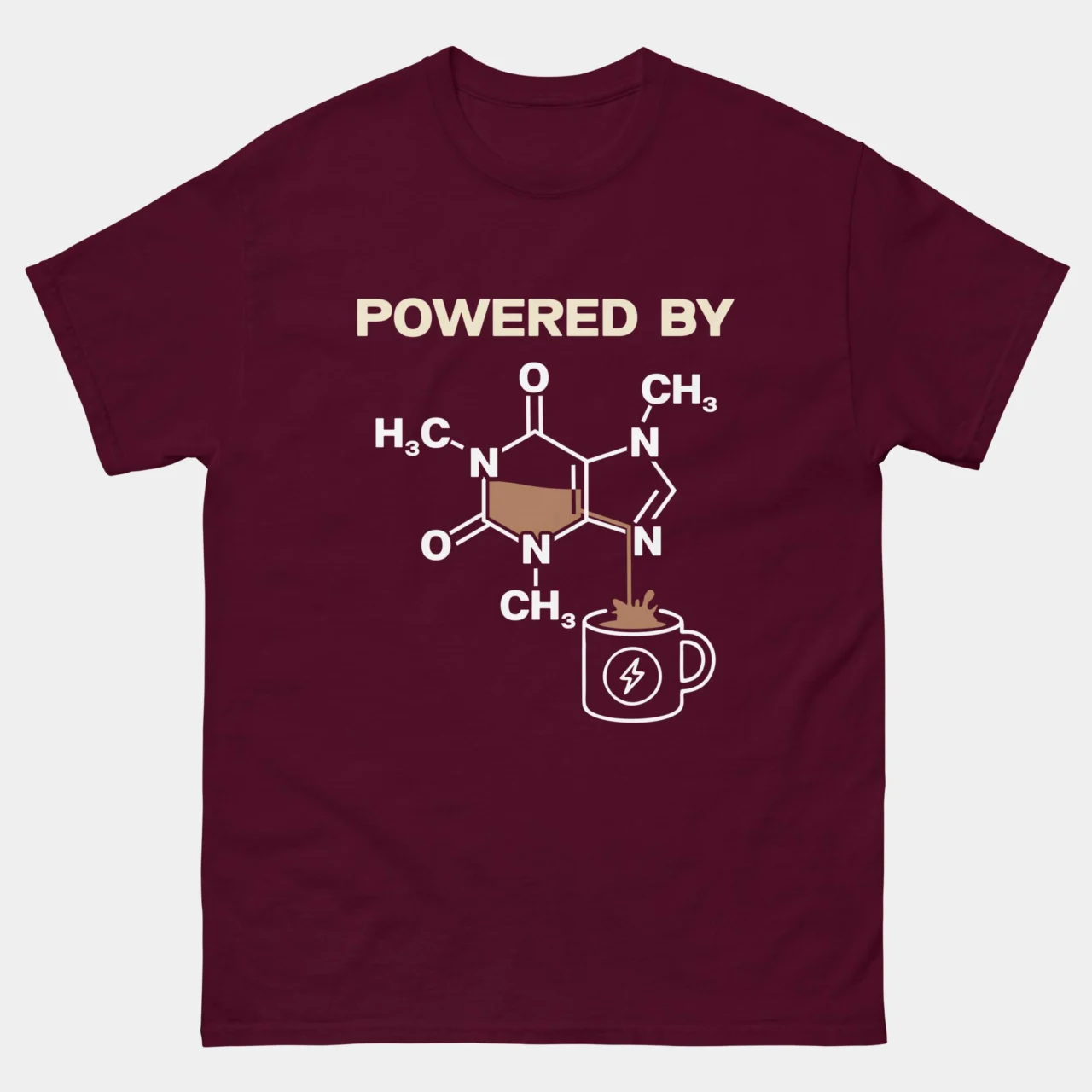 Maroon Powered By Caffeine Funny Chemistry Shirt showing the caffeine molecule structure pouring into a coffee mug above the text Powered By, science humor graphic tee for chemists and coffee lovers