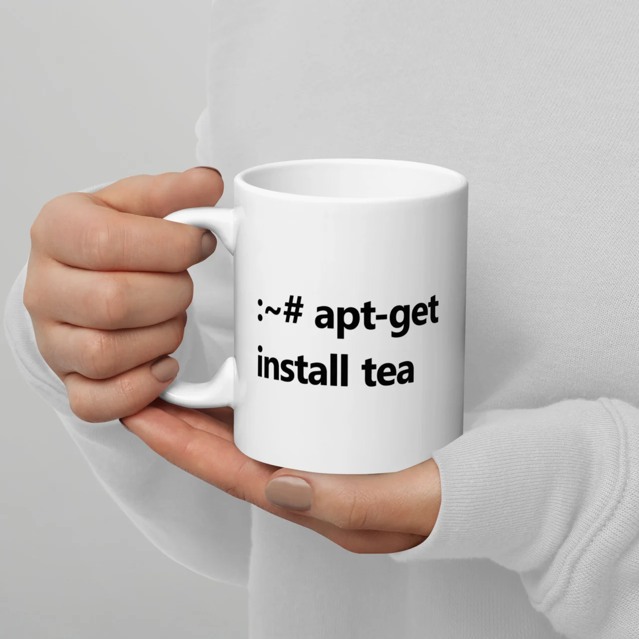 White ceramic mug printed with the Linux terminal command ":~# apt-get install tea" in bold black text, a funny tea mug for programmers - Apt-Get Install Tea Funny Terminal Mug
