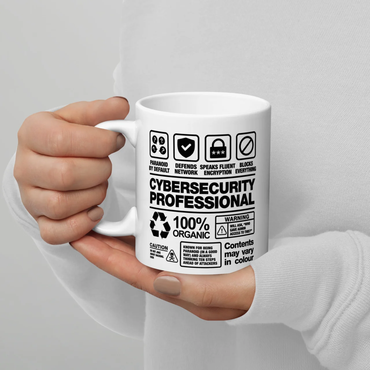 White ceramic mug styled like a product warning label reading "Cybersecurity Professional, 100% Organic," a Cybersecurity Professional Label Funny Mug for security professionals