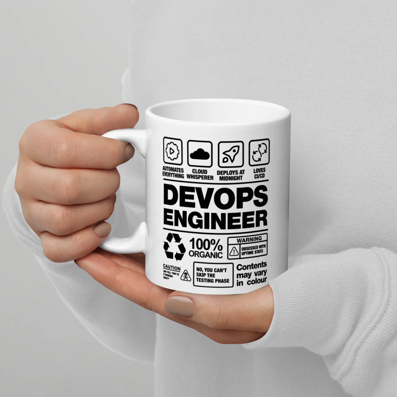 White ceramic mug styled like a product warning label reading "DevOps Engineer, 100% Organic," a DevOps Engineer Label Funny Tech Job Mug for DevOps engineers