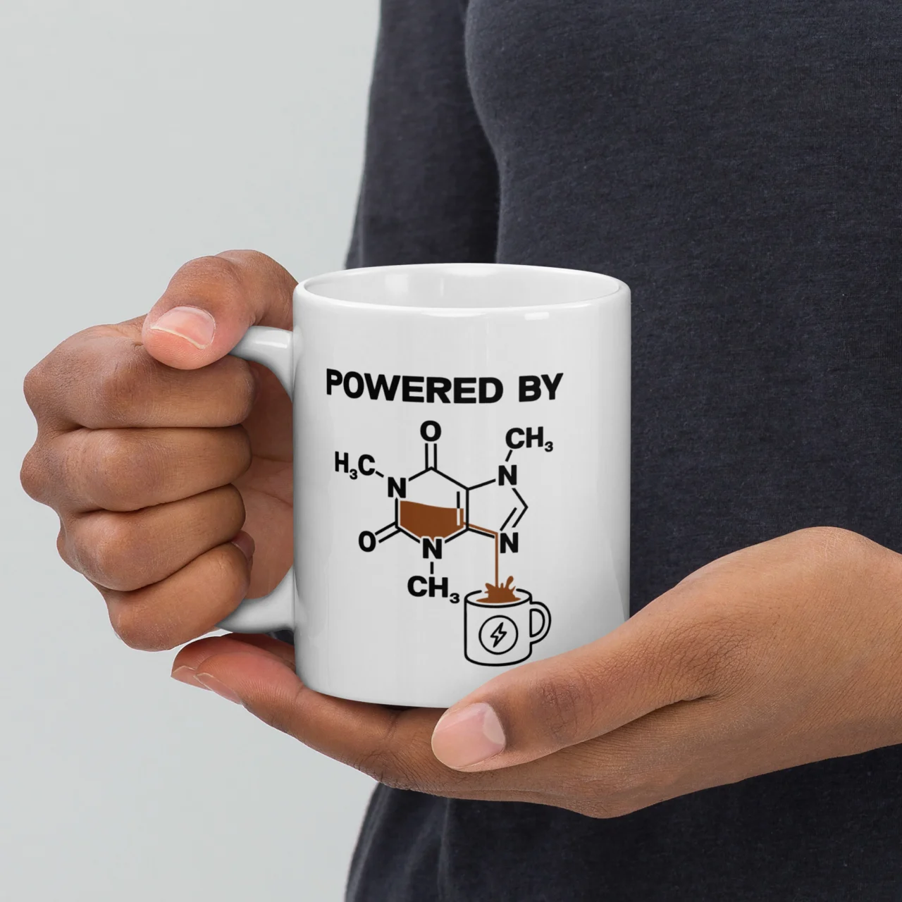 White ceramic mug with the caffeine chemical molecule structure pouring into a small mug icon under the text "Powered By," a funny chemistry coffee mug - Powered By Caffeine Funny Science Mug
