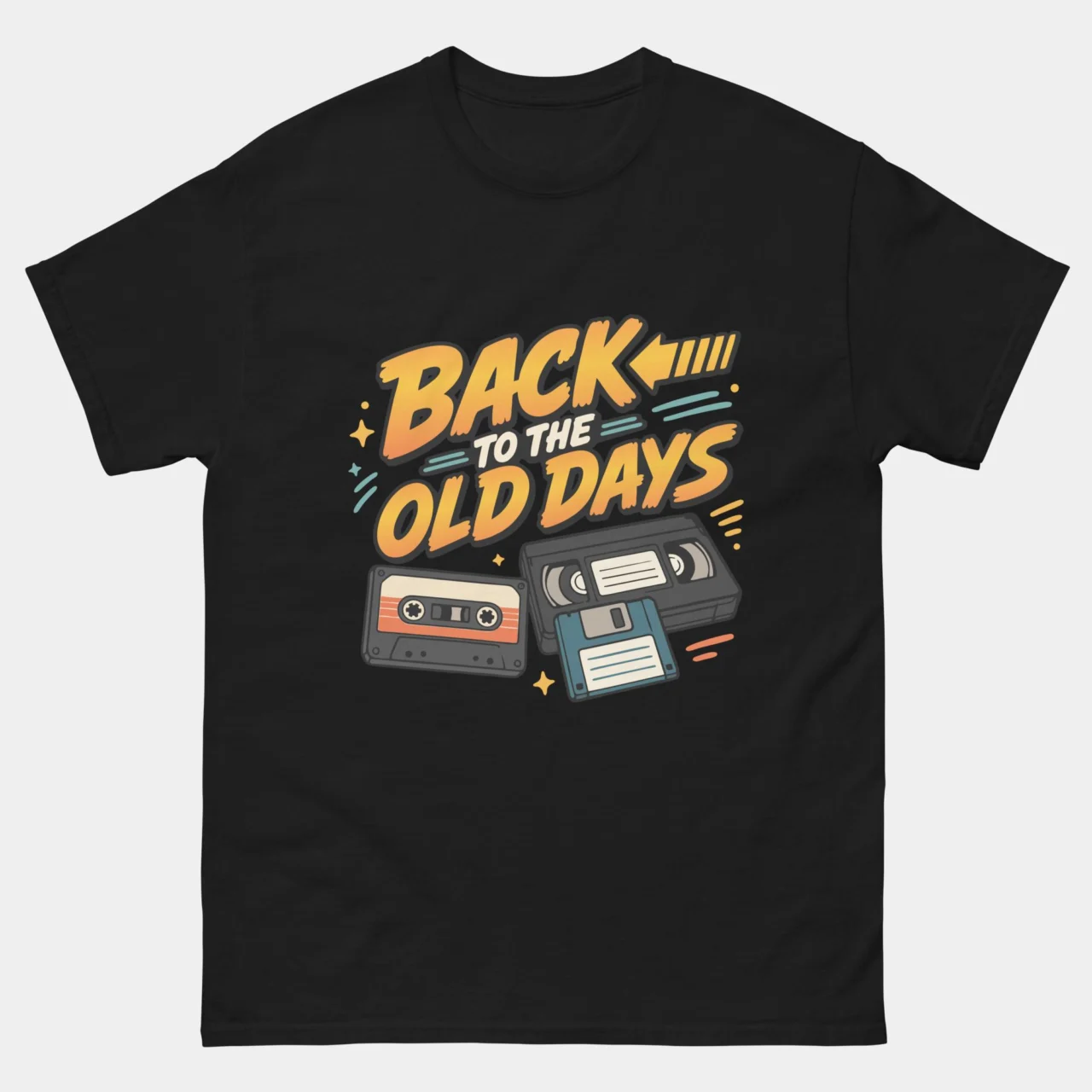 Black Back To The Old Days Retro Tech Nostalgia T-Shirt with retro lettering and illustrations of a cassette tape, VHS tape and floppy disk