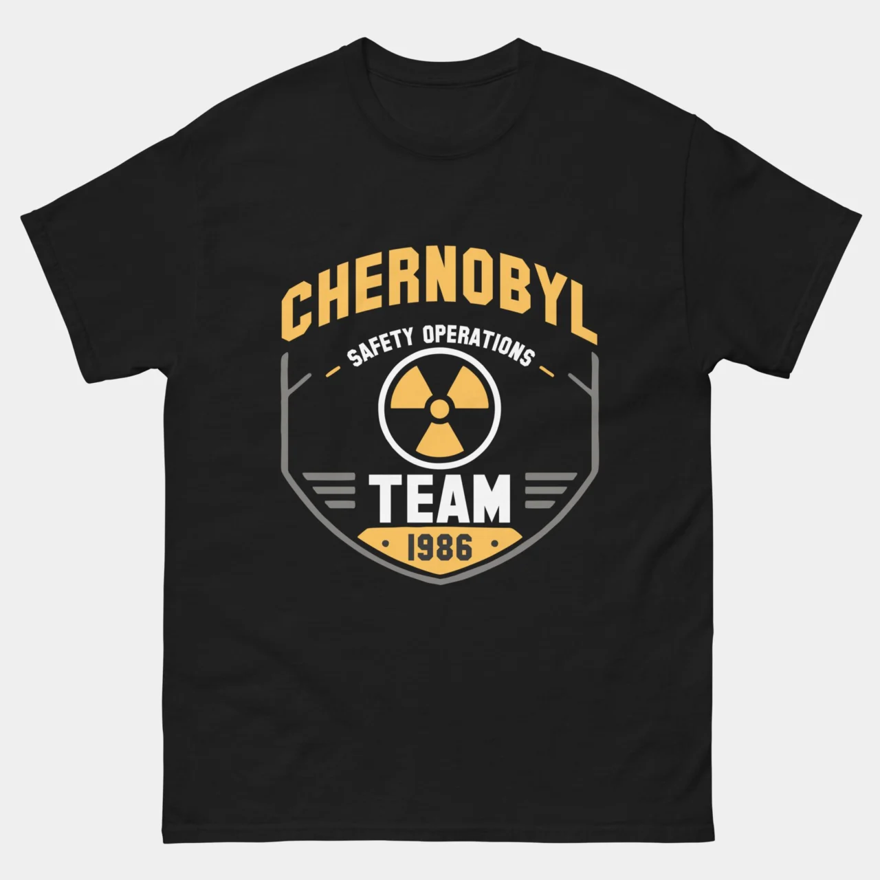 Black Chernobyl Safety Operations Team 1986 Tee with a yellow and gray shield badge featuring a radiation symbol